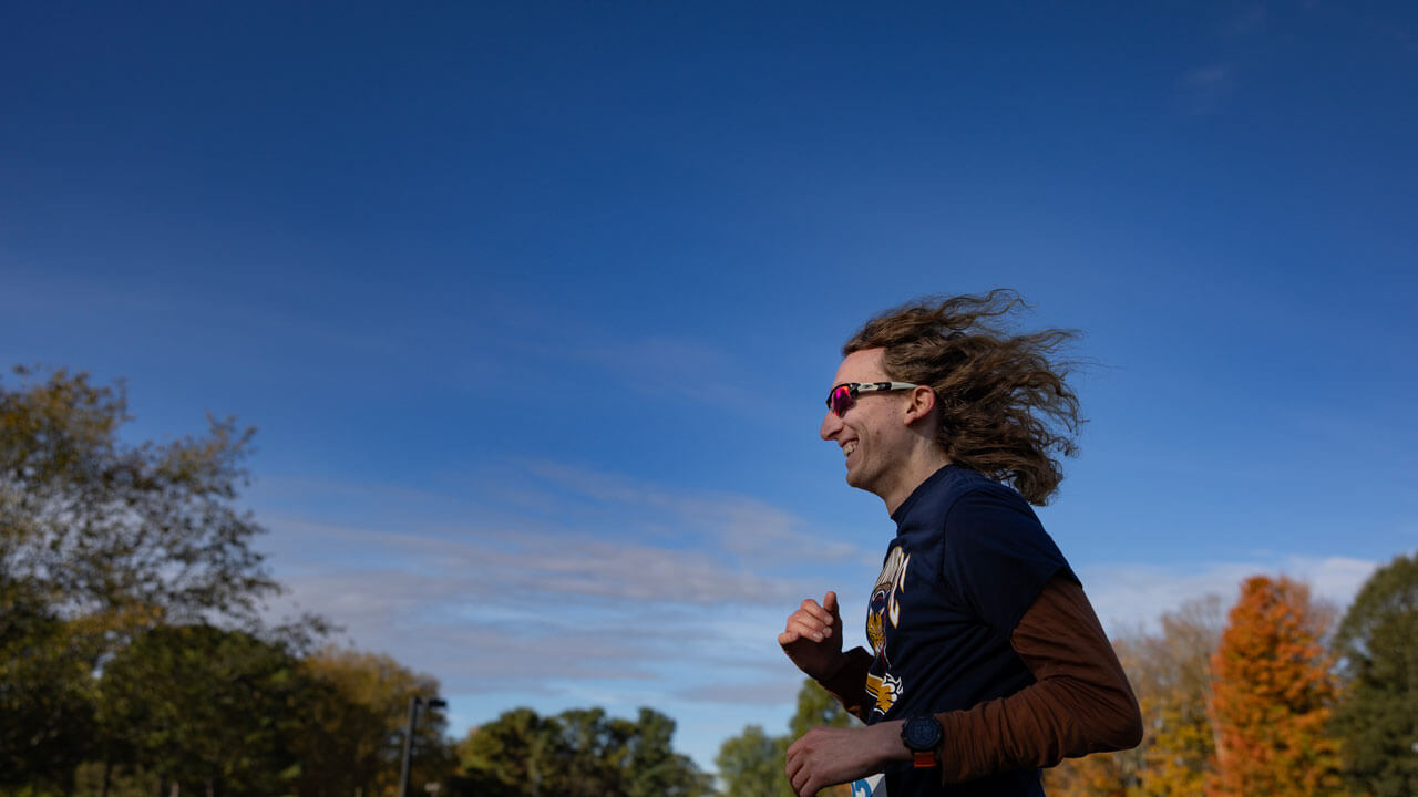 Runner racing with a smile on their face