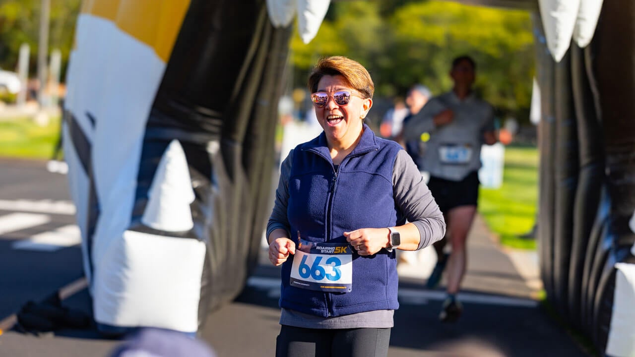 Runner in sunglasses with an excited look after finishing the race