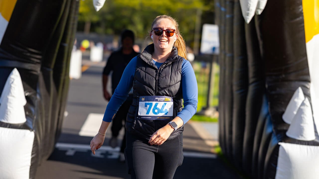 Runner walks through bobcat head to finish the race with a smile