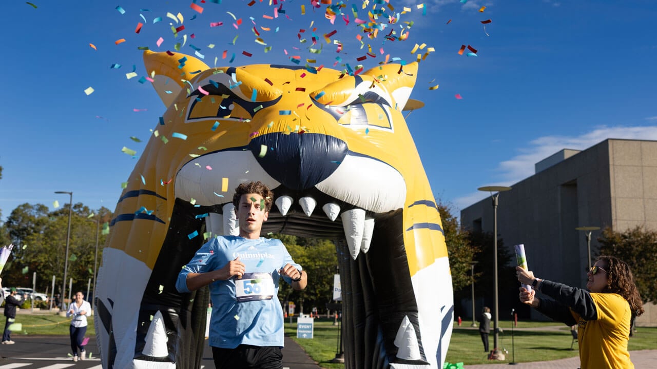 Runner finishing the race with confetti flying in the air