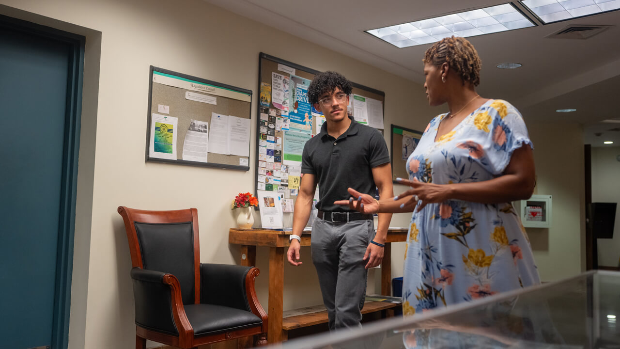 Student speaks with woman at the Hamden Town Clerk’s Office.