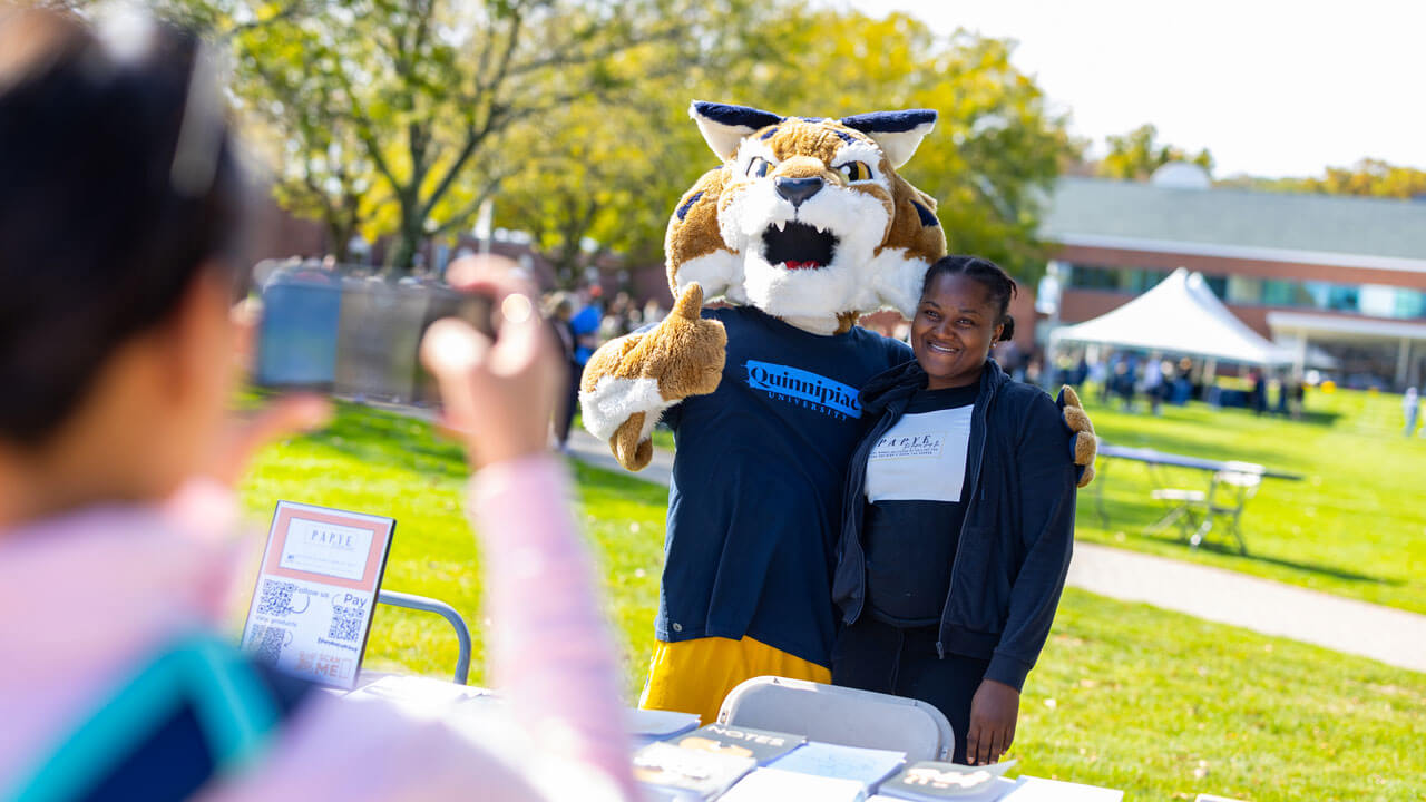 Boomer holding a thumbs up with a fellow bobcat