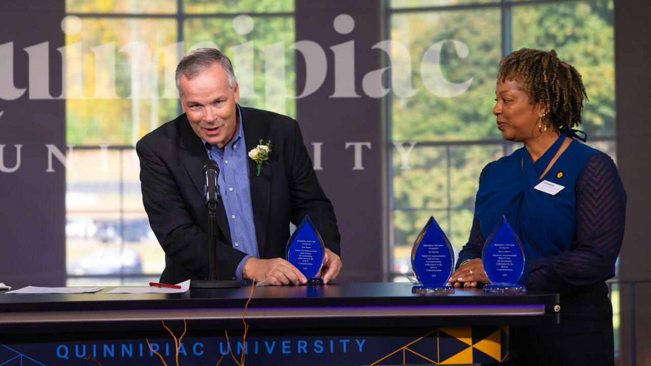Dean Nadine Barnett Cosby looks to her side at another speaker
