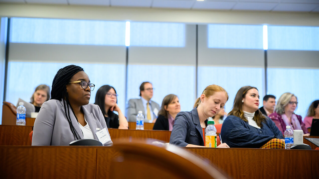 A woman attentively listening to a presentation