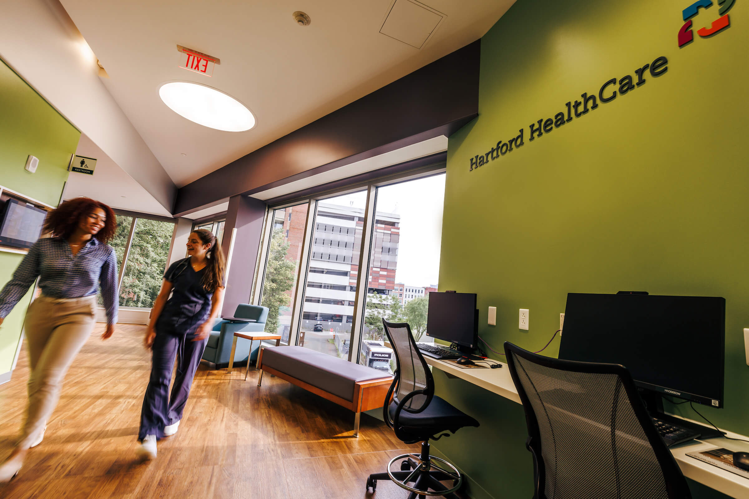 Two employees walk the halls of Hartford Healthcare