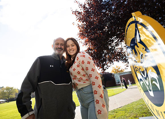 Student and parent pose for picture during Bobcat Weekend