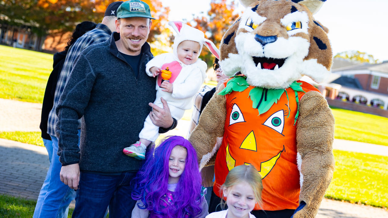 Family poses in costume with Boomer