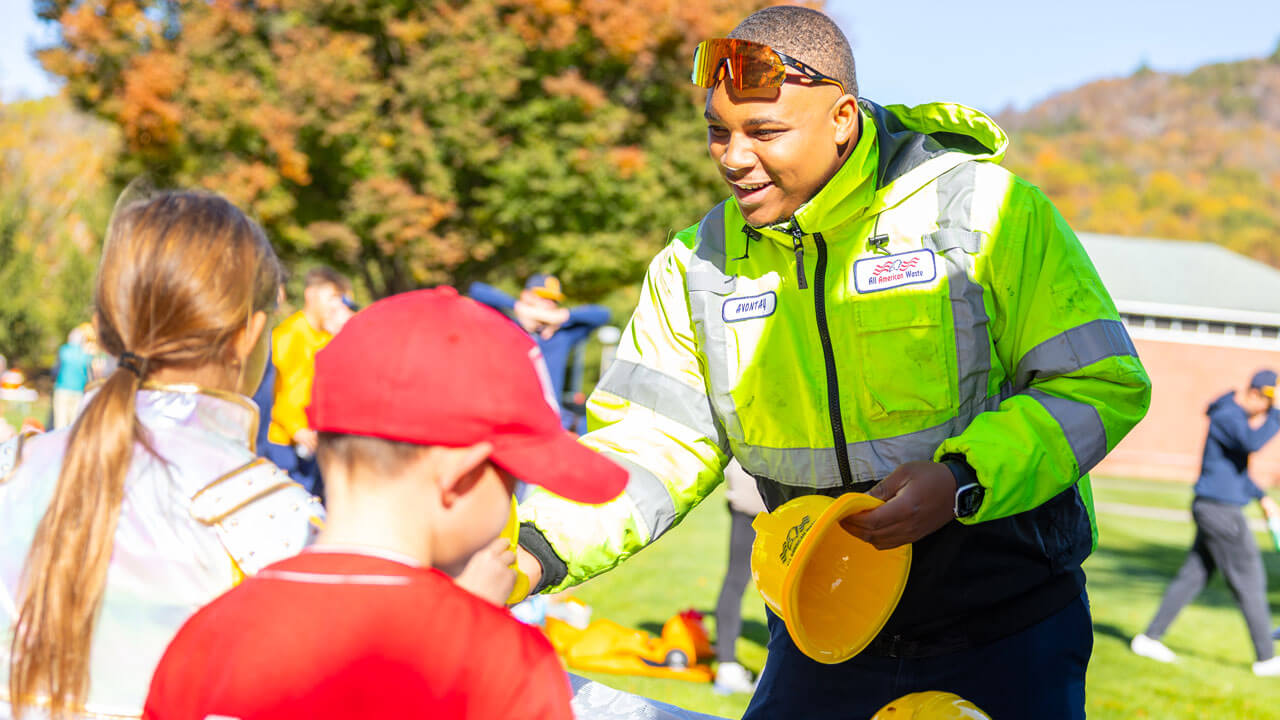 Man passes out hard hats to Boomer's Boo Bash attendees