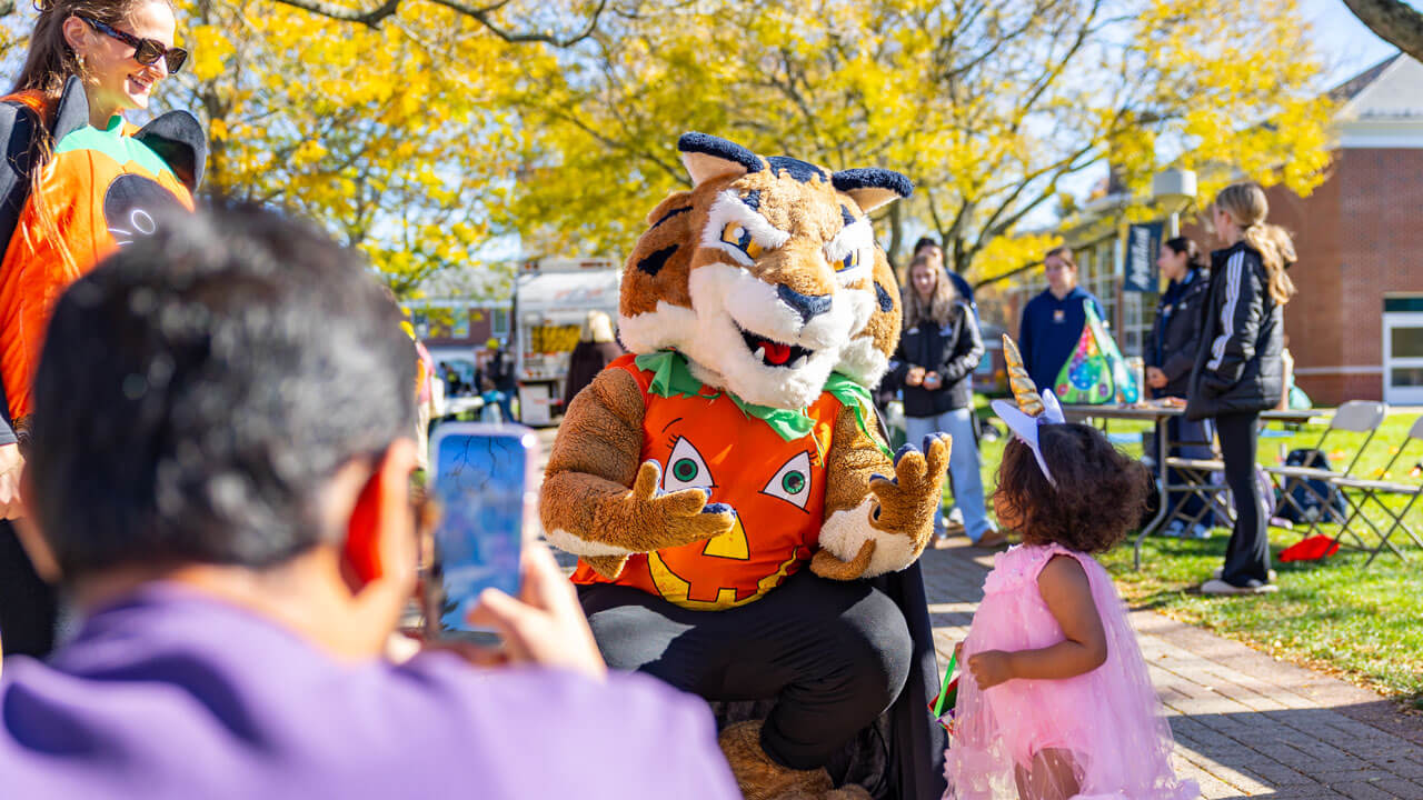 Boomer talking to a young child while parent takes a photo