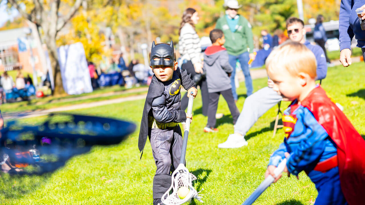 Children playing around with lacrosse sticks