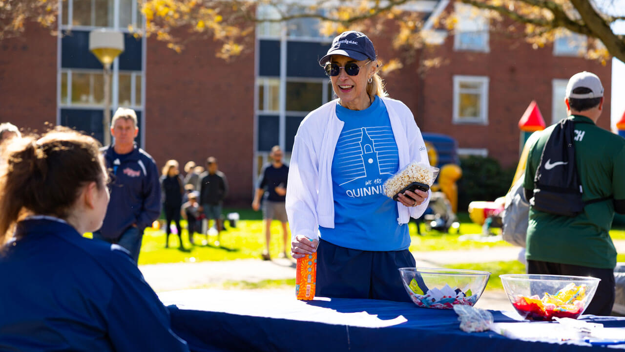 President Marie Hardin smiles as she talks to an attendee of Boomer's Boo Bash