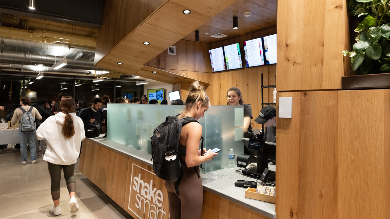 A student waiting for her order from Shake Smart