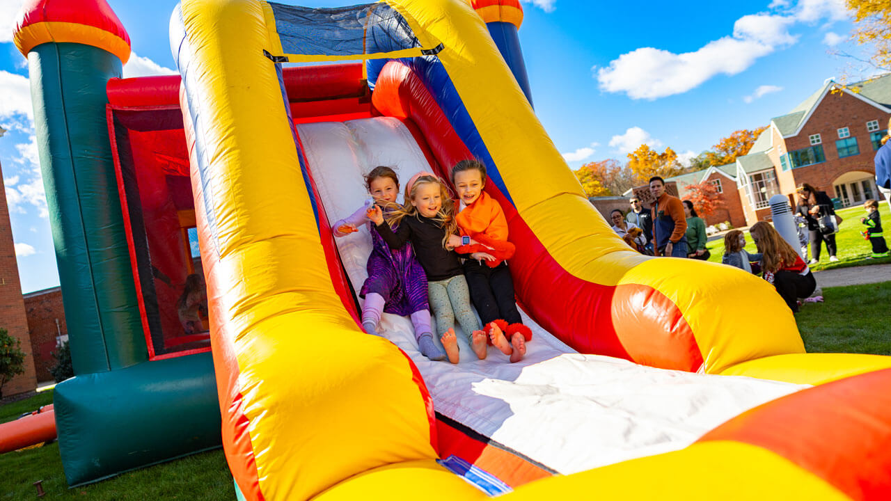 Inflatable slide with people going down it