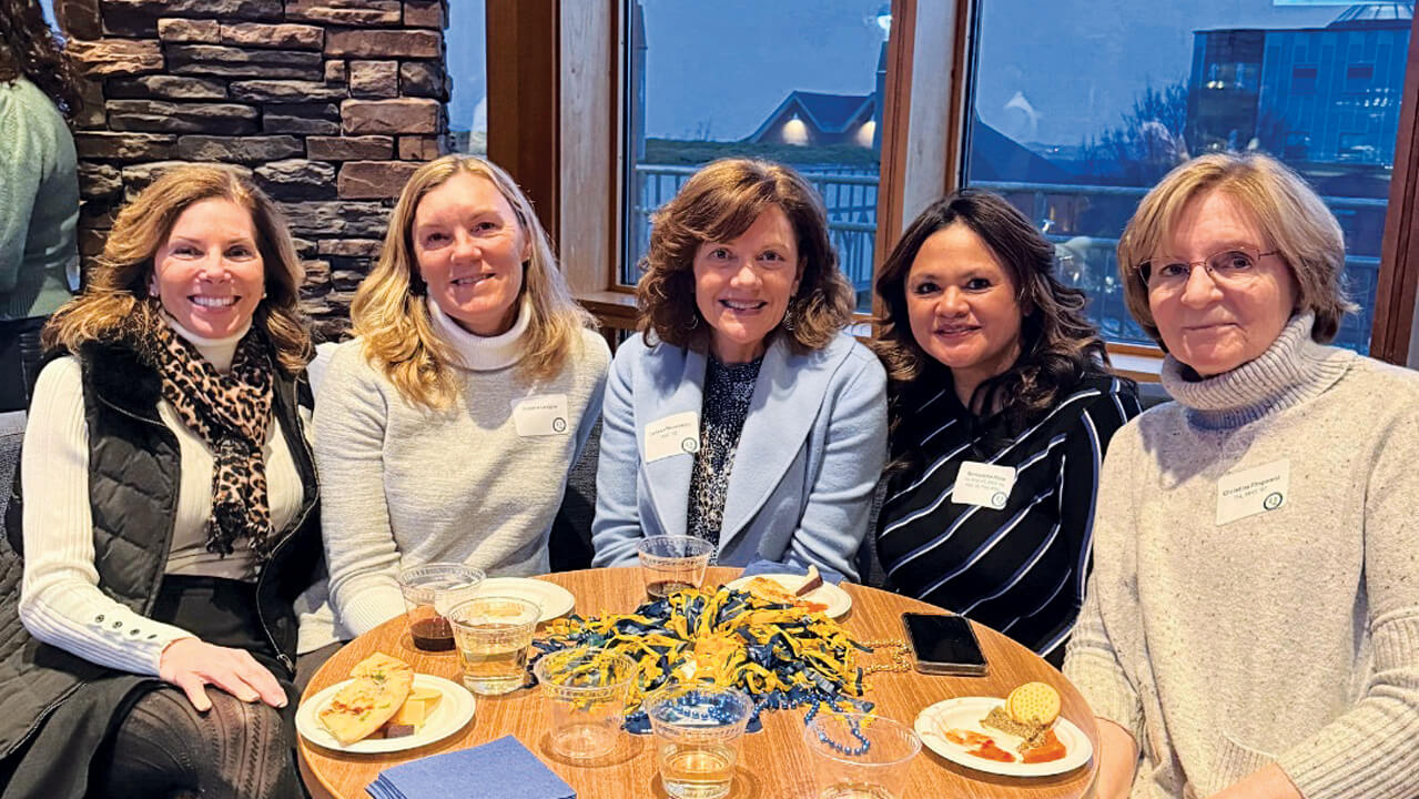 Faculty and alumni gather for a happy hour on January 6, 2025