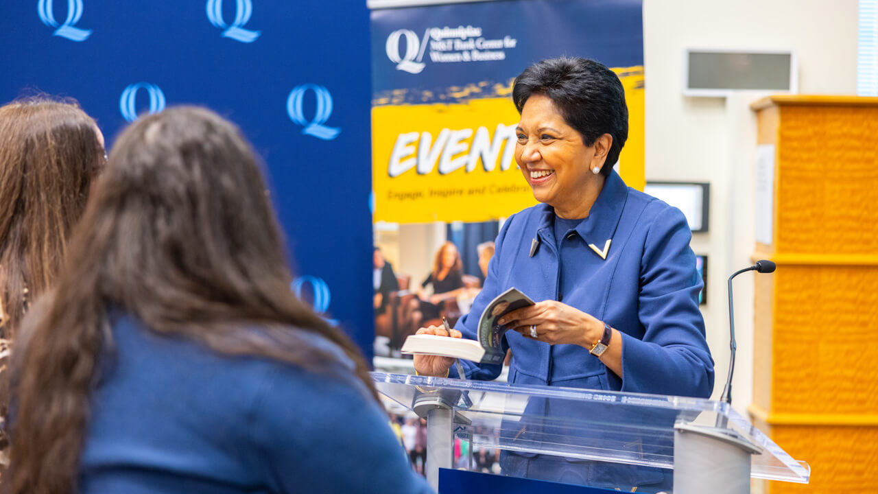 indra nooyi speaking at a podium