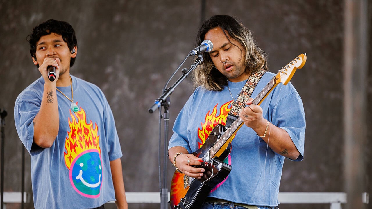 Peach Tree Rascals singing and playing guitar on stage at fall fest