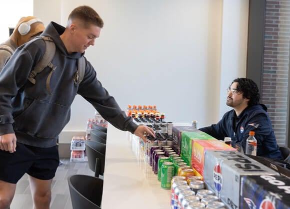 Student reaches for pepsi products