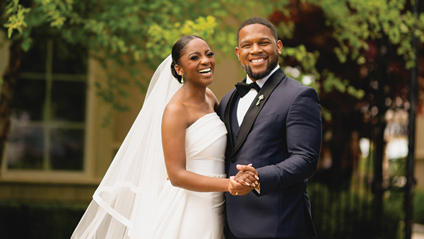 Asia (Skyers) Sumner and Bryan Sumner smile and hold hands on their wedding day