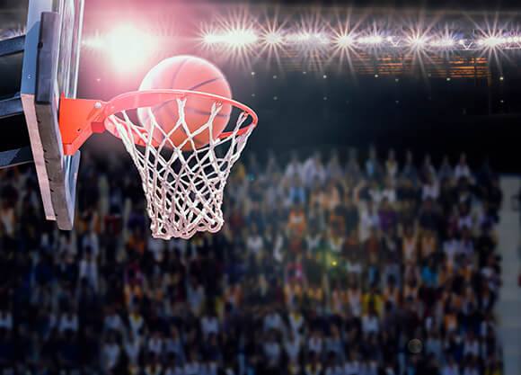 A basketball going through a net