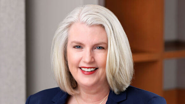 Robyn Swanson smiling in a blue and red top