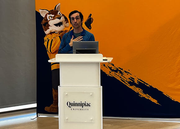 Jamie DeLoma speaks at a podium