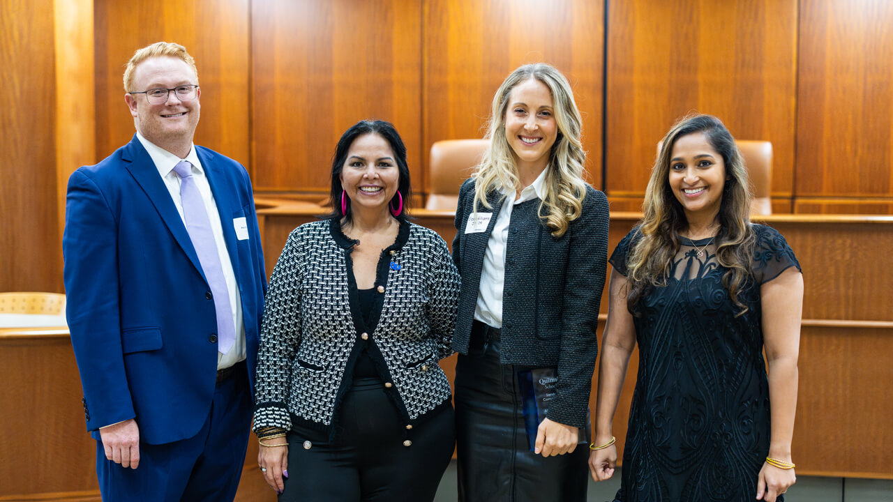 School of Law alumni award winners hold their awards and pose with law faculty and staff