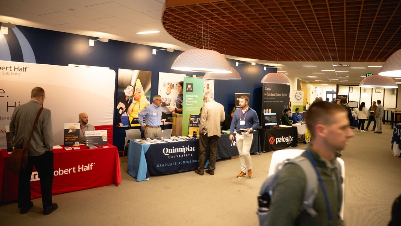 People shake hands at tables
