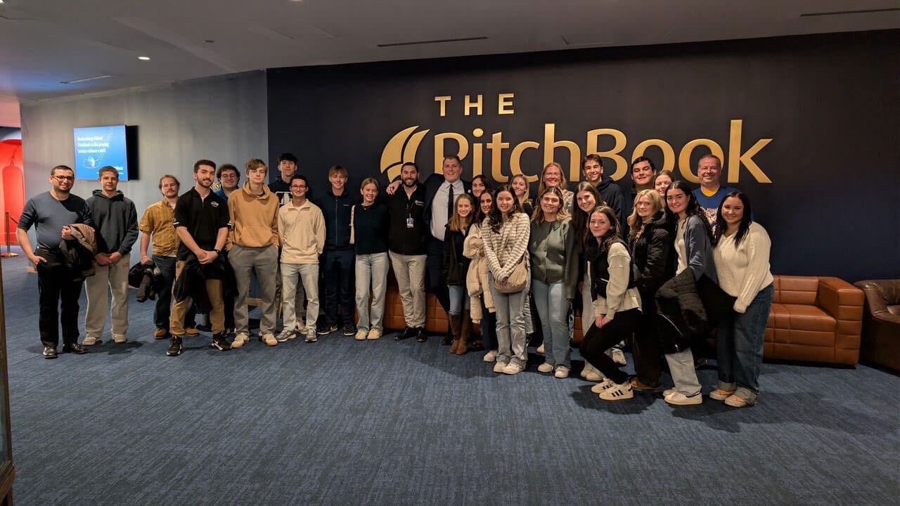 Students and Quinnipiac Alumni pose together