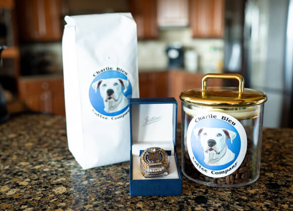 Charlie Bleu coffee bag and jar with a Quinnipiac Frozen Four ice hockey champions ring