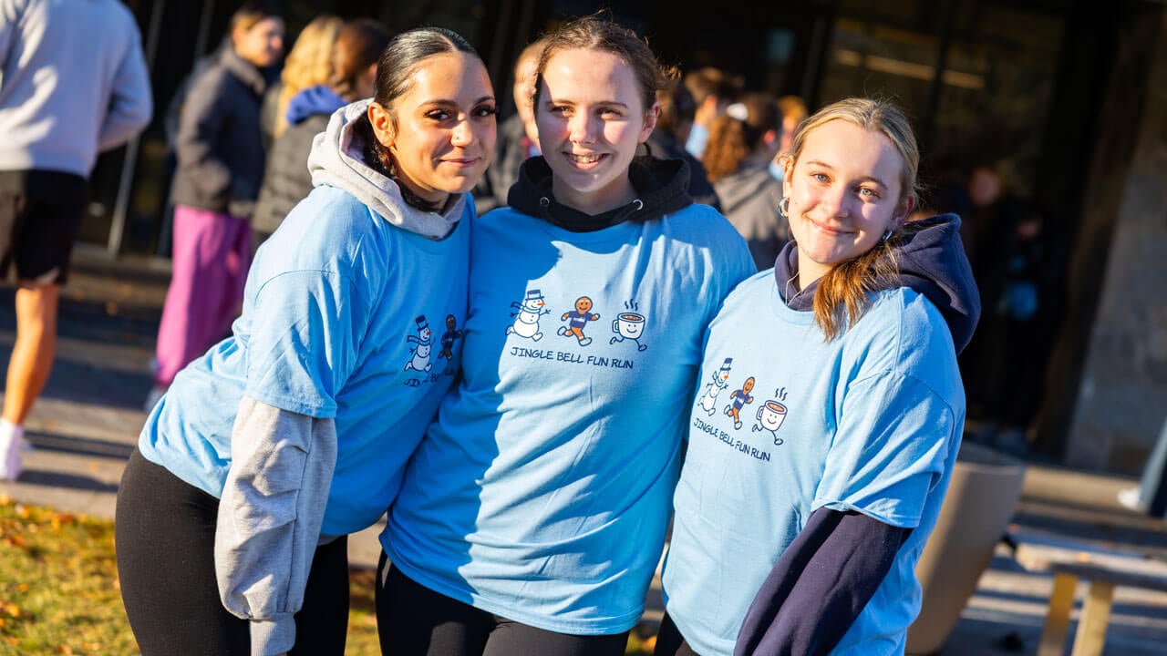 Three participants of the 2025 Jingle Bell Fun Run