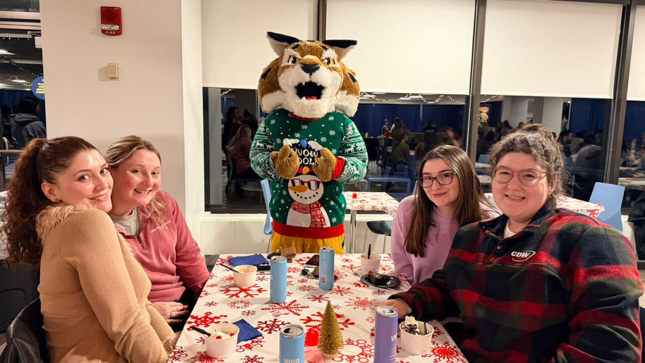 Students pose for a photo with Boomer
