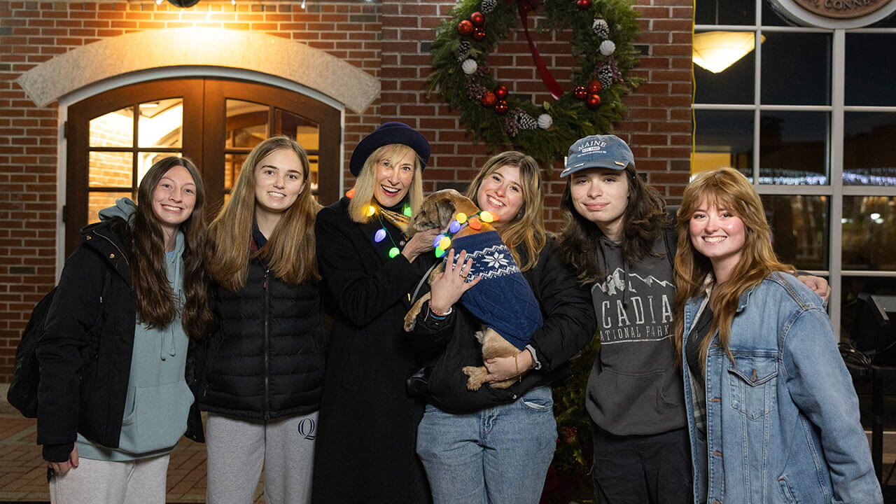 Students pose with President Marie Hardin after the Quad Lighting