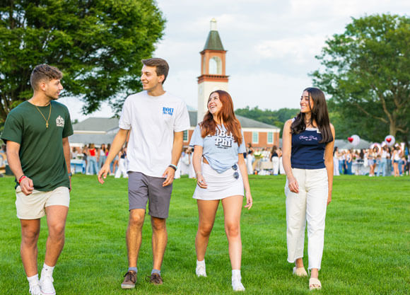 Four fraternity and sorority walk and talk across the quad