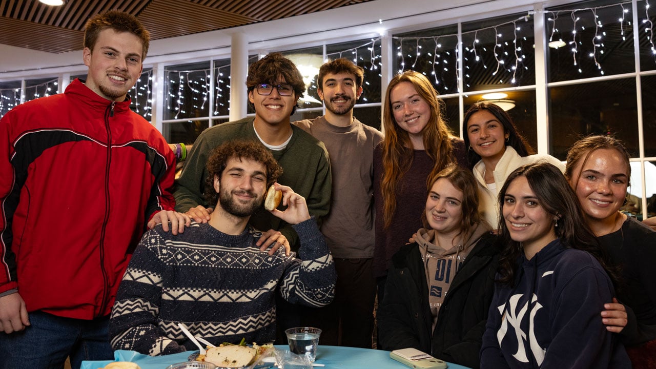 Students gather for a picture together at the annual undergraduate holiday dinner