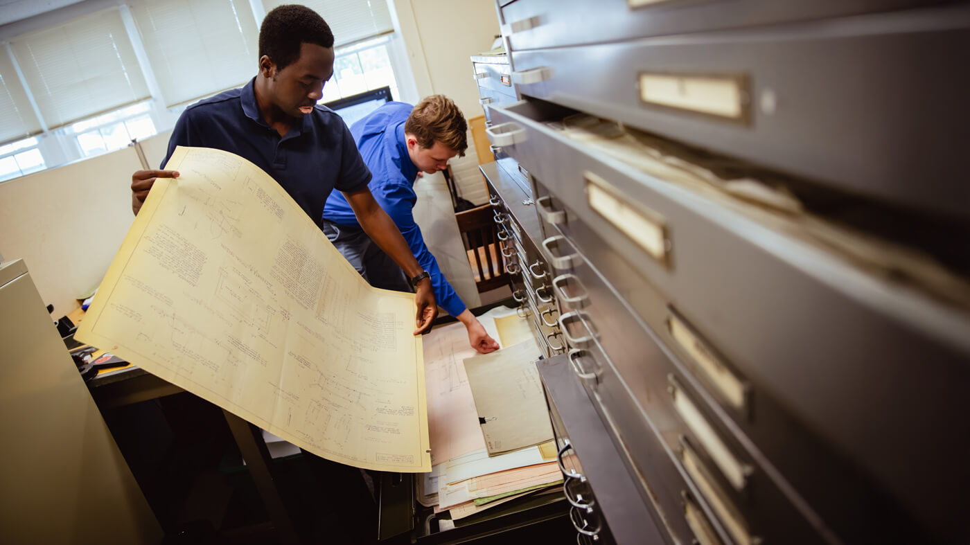 Students work in a filing cabinet as part of the public service project