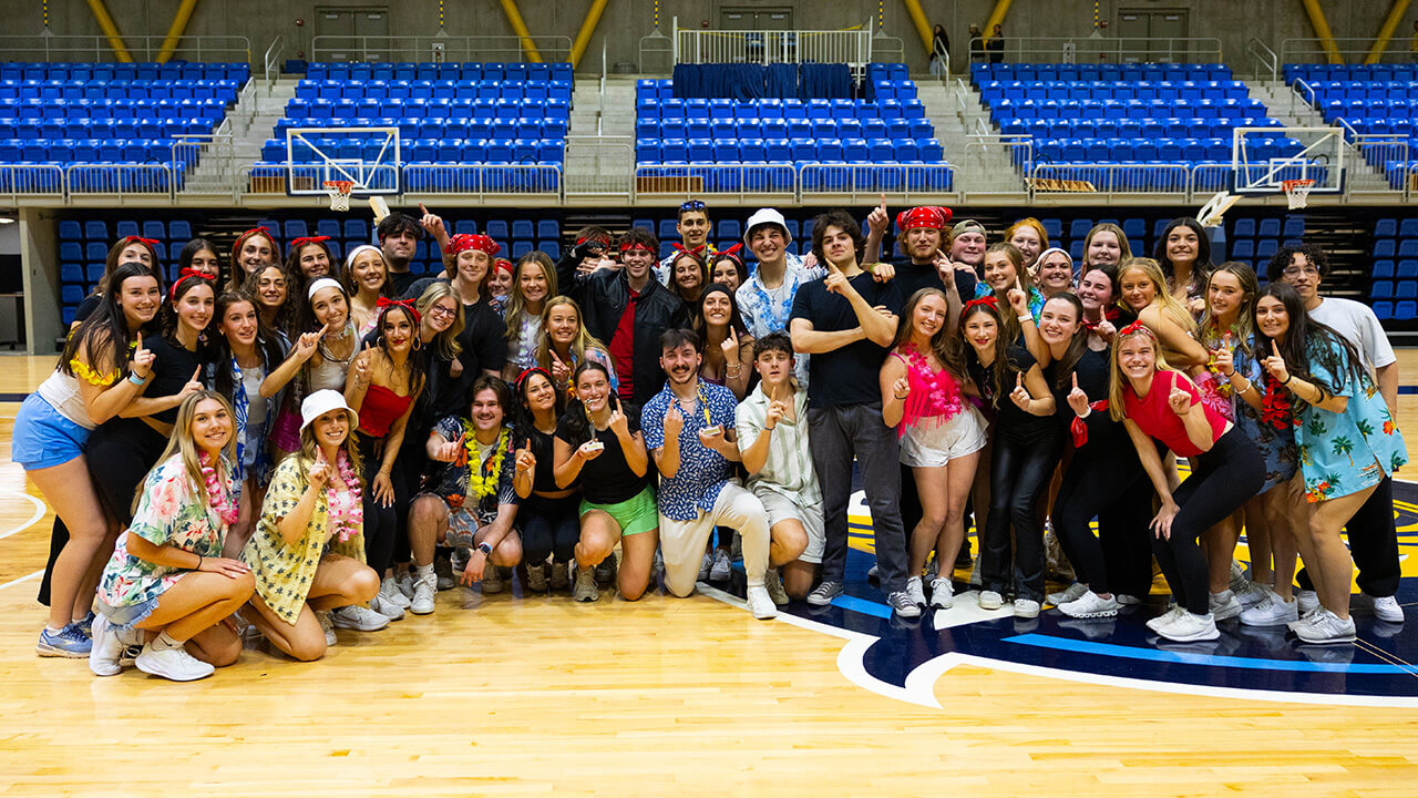 Sorority and fraternity members pose for group photo after winning annual lip-sync battle