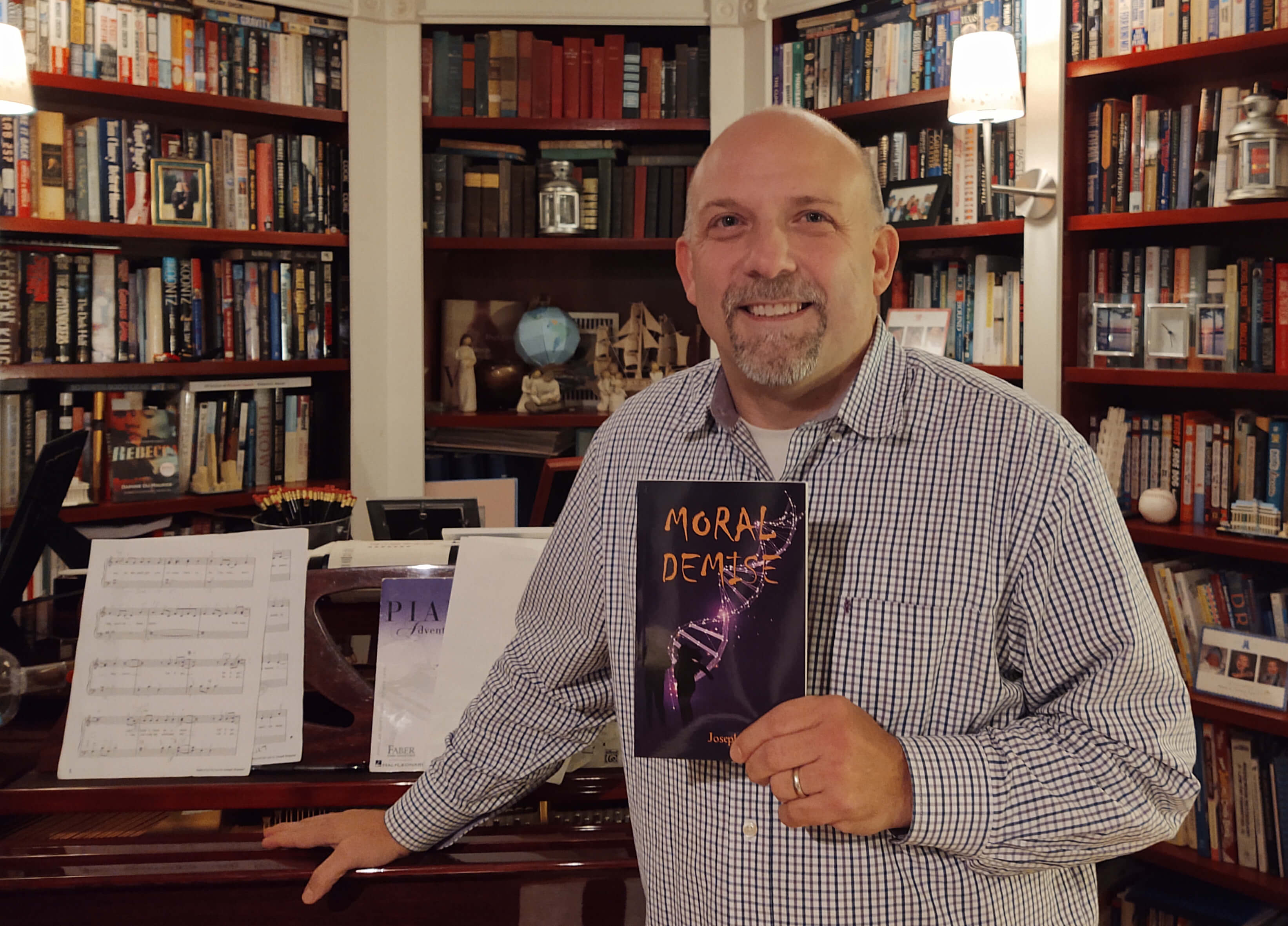 Joe Briganti with his book "Moral Demise"