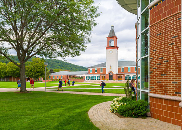 students walking around outdoor campus courtyard