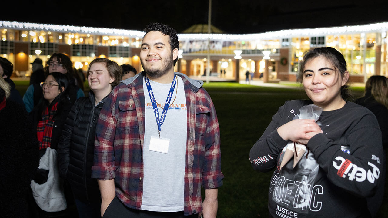 Students smile and receive hot cocoa mix