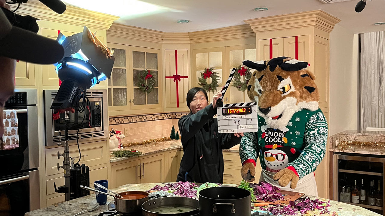 Boomer the Bobcat on set with a crew member in the kitchen