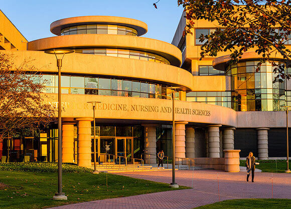 Outside of the center for medicine, nursing and health sciences at dusk