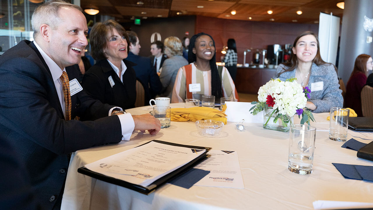 people around a table at a Quinnipiac networking event