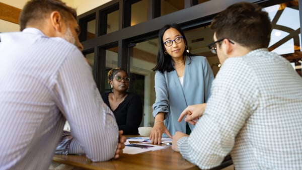 Individuals having a meeting in a conference room
