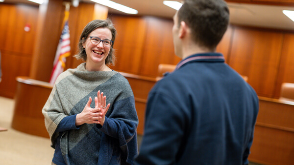 Faculty talking with an individual